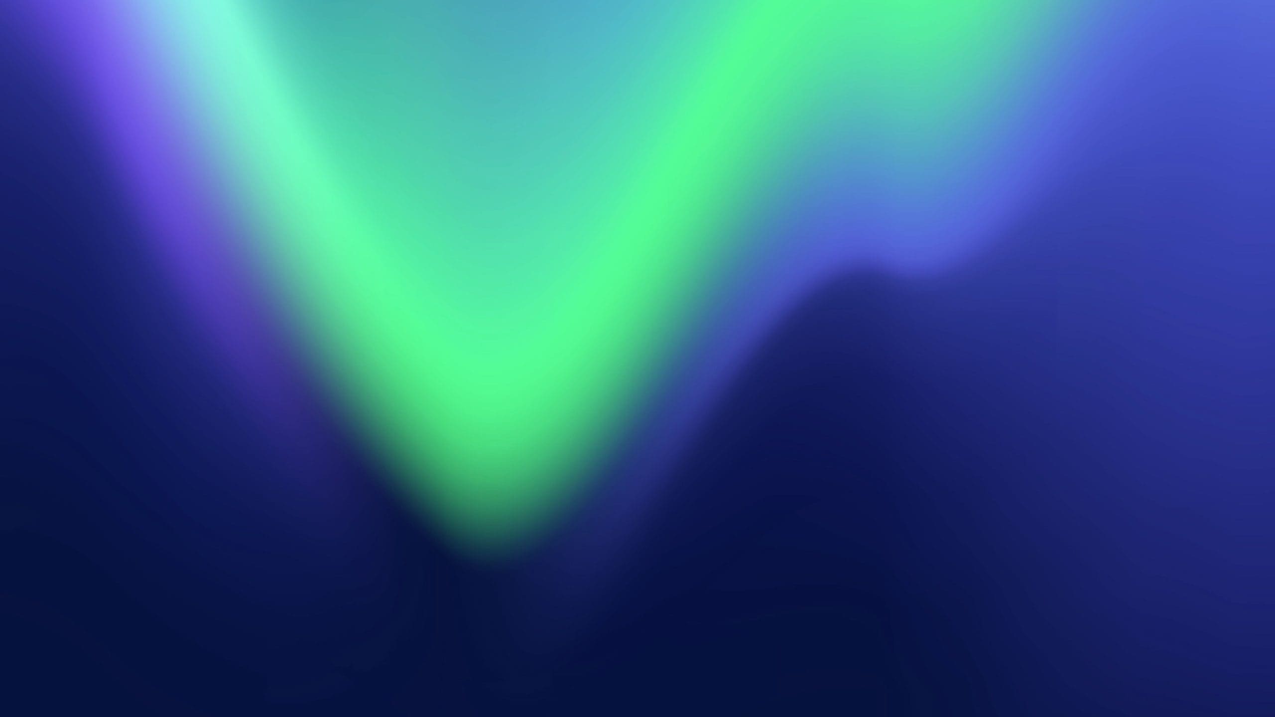 Abstract blurred waves of vivid green, turquoise and blue light flowing across a deep navy background.